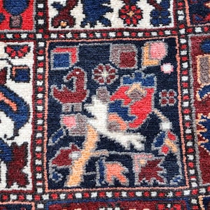 The image is a close-up of a colorful, intricately designed rug with various patterns and shapes.