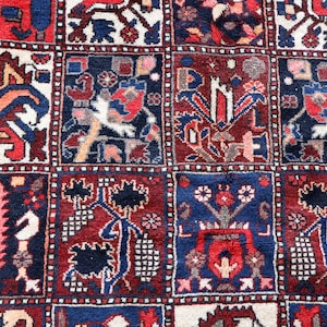 The image is a close-up of a vibrant, intricately patterned rug with a variety of designs and colors.