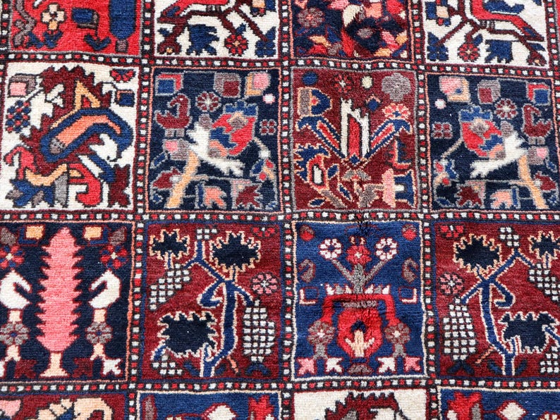 The image is a close-up of a vibrant, intricately patterned rug with a variety of designs and colors.