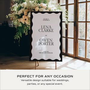 Welcome sign on easel with lush florals by a window; monochrome wavy border and classic fonts; modern wedding welcome board template editable in Canva; perfect for entrances, photo spots and bar areas; instant download printable.