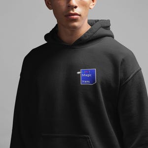 May include: Black hoodie with a blue and white patch that says "Limit Magic Item" on it.