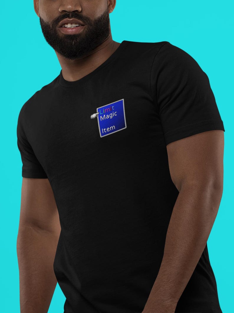 May include: Black t-shirt with a blue square graphic that reads "Limit Magic Item". The graphic has a white border and a gradient blue fill. The shirt is made of a soft material.