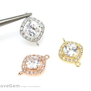 May include: Three square-shaped pendant connectors with a clear cubic zirconia stone in the center and a halo of smaller stones. The connectors are available in silver, gold, and rose gold.