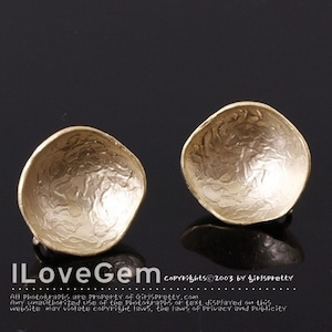 May include: A pair of gold-toned clip-on earrings with a textured, hammered finish. The earrings are round and have a slightly domed shape.