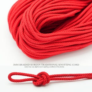 May include: A coil of bright red 3mm braided knotting cord with a textured surface. Below the coil, a single strand of the same red cord is tied into a small loop knot. The text 3MM BRAIDED KOREAN TRADITIONAL KNOTTING CORD is visible.