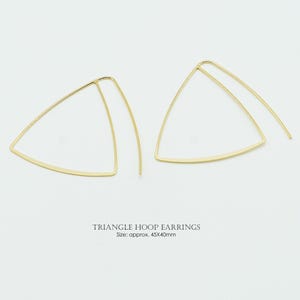 May include: A white ceramic mug with a black handle and the text "But First, Coffee" in a bold, black font. The mug is set against a blurred background, suggesting a cozy setting.