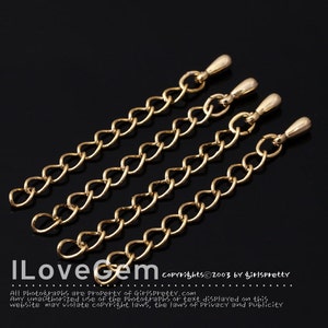 May include: Four gold-colored chain extenders with a teardrop-shaped end piece. The chains are approximately 1.5 inches long.