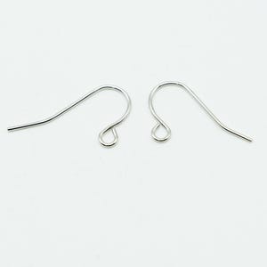 May include: A pair of silver-toned metal earring hooks, each featuring a curved wire design with a small circular loop at the bottom for attaching jewelry components. These findings are smooth, polished, and shaped for insertion into ear piercings.