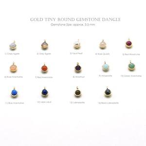 Puede incluir: Una colección de pequeños colgantes redondos de piedras preciosas doradas. Las piedras preciosas incluyen ágata loca, ágata gris, perla falsa, cuarzo rosa, línea de madera roja, aventurina rosa, aventurina roja, amatista, amazonita, aventurina verde, aventurina azul, lapislázuli, labradorita y labradorita negra. Tamaño de la piedra preciosa: aprox. 3,5 mm.