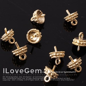 May include: Close-up of ten gold-toned metal bead caps with loops. The bead caps are designed to be used as end caps for necklaces, bracelets, or other jewelry projects.