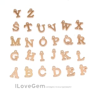 May include: Gold-toned metal alphabet letter charms. The letters are in uppercase and are arranged in alphabetical order. The letters are all the same size and shape. The charms are perfect for adding a personal touch to jewelry or crafts.