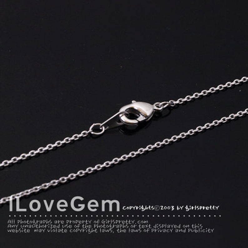 May include: A silver-colored necklace chain with a lobster clasp. The chain is made of small, interconnected links. The image includes the text "ILoveGem" and copyright information.