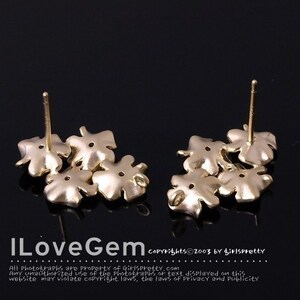 May include: Two gold-toned metal stud earrings, each featuring a cluster of four-leaf clover shapes. The earrings have straight posts extending from the back. The text ILoveGem and copyright information are visible at the bottom of the image.