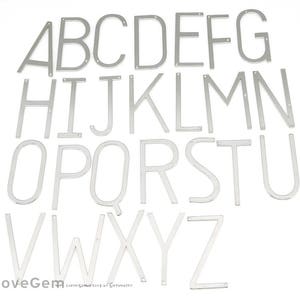 May include: A set of silver metal alphabet letters, A through Z, in a simple, modern font style. The letters are arranged in alphabetical order.