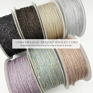 May include: Spools of 1.5mm metallic braided jewelry cord in various colours, including black, gold, silver, and lavender. The text on the image reads: 1.5MM METALLIC BRAIDED JEWELRY CORD. Beading Macrame String Thread For Making Necklace, Bracelet!