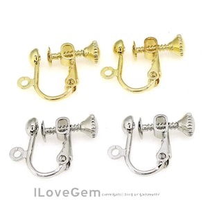 May include: Two pairs of earring clips, one pair is gold and the other is silver. The clips are made of metal and have a screw-on design.