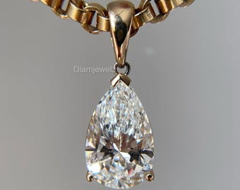 May include: A gold chain necklace with a pear-shaped diamond pendant.