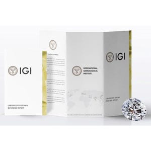 May include: A sparkling, brilliant-cut diamond is displayed beside a white brochure and a folded report. The brochure and report feature the IGI logo and text, "Laboratory Grown Diamond Report" and "International Gemological Institute".