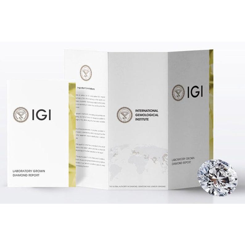 May include: A sparkling, brilliant-cut diamond is displayed beside a white brochure and a folded report. The brochure and report feature the IGI logo and text, "Laboratory Grown Diamond Report" and "International Gemological Institute".