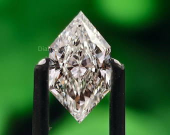 May include: A clear, radiant-cut diamond held by black tweezers against a blurred green backdrop. The diamond's facets reflect light, creating a brilliant sparkle. The diamond is kite-shaped, with sharp, pointed corners.