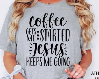 May include: Light grey t-shirt with the text "Coffee Gets Me Started, Jesus Keeps Me Going" in black script. The shirt is heathered and has short sleeves. The text "Athlethich Heather Light Grey" is printed on the right side of the shirt.
