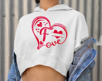 May include: White cropped hoodie with a red heart design. The heart has a large letter "F" inside and the word "love" written below. There is a small space inside the heart for a name.