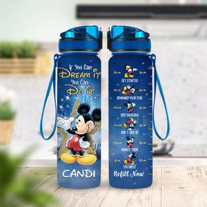 May include: Blue water bottle featuring Mickey Mouse with the text "If You Can Dream It You Can Do It". The bottle has a blue lid and strap, with a time tracker and the name "Candi".