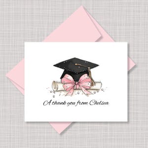 May include: A graduation-themed greeting card with a black mortarboard, pink bow, and rolled diploma. The card includes the text "A thank you from Chelsea" in elegant script, with a pink envelope in the background.