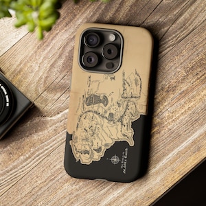 May include: A tan and black smartphone case featuring a detailed map of Middle-earth. The design includes intricate black line work depicting geographical features, labels, and a compass rose. The text reads The Realm of Middle-earth.