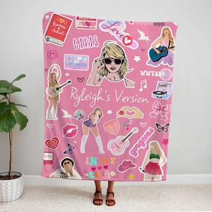 May include: Pink blanket featuring various illustrations and text, including the words "GIRLS", "Love", and "Ryleigh's Version". The blanket has images of a woman with sunglasses, guitars, hearts, and other graphics.