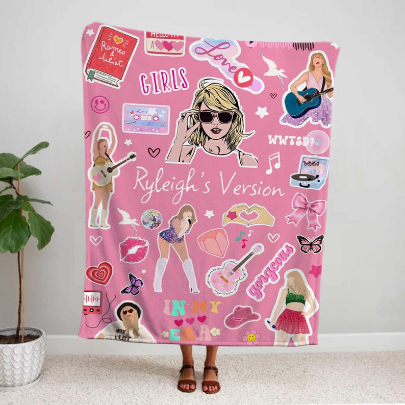 May include: Pink blanket featuring various illustrations and text, including the words "GIRLS", "Love", and "Ryleigh's Version". The blanket has images of a woman with sunglasses, guitars, hearts, and other graphics.