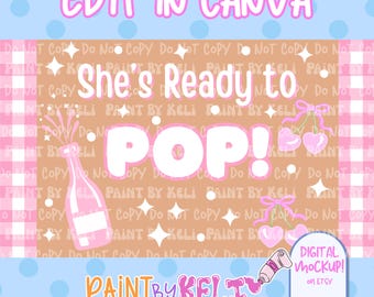May include: A digital mockup design with the text "EDIT IN CANVA" at the top. The phrase "She's Ready to POP!" is in the center, with a pink champagne bottle illustration. The design includes pink cherries and the text "PAINT BY KELI" at the bottom.