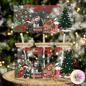May include: Clear glass tumbler with a wooden lid and straw, featuring a spooky Christmas design. The design includes a gingerbread skeleton, a snowman skeleton in a snow globe, and a Ouija board. The text reads "Sorta Merry Christmas, Sorta Scary."
