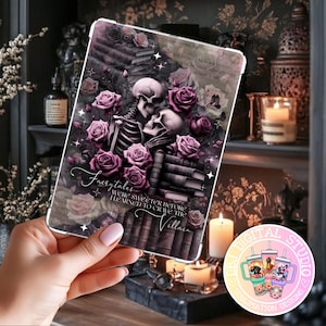 May include: A tablet case featuring a gothic design with skeletons, roses, and books in shades of purple and gray. The text "Fairytales were sweeter before I learned to crave the Villain" is displayed on the case.