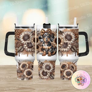 May include: A white stainless steel tumbler with a black lid and handle. The tumbler features a design of a dachshund wearing a bow and sunflowers on a brown and white background.