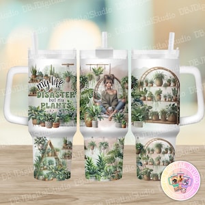 May include: White tumbler with a green, brown, and white design featuring a woman sitting in a hanging chair surrounded by plants. The text on the tumbler reads "My life is a disaster but my plants are thriving."