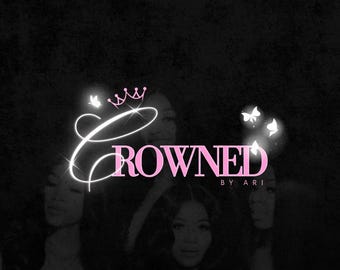 May include: A pink and white logo design featuring the text "Crowned by Ari" and a crown graphic. The logo is set against a black background with a group of people in the background.