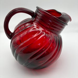 Vintage Anchor Hocking Ruby Red pitcher.  with slanted ice lip and tilted swirl pattern ball glass pitcher