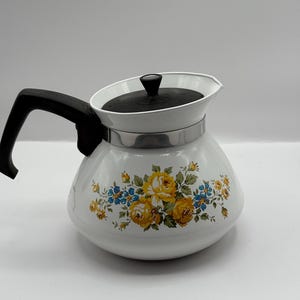 VTG Corning Ware Lancaster teapot featuring yellow and blue flower 5” Hx7.5D