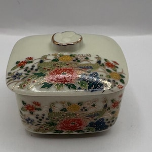 Vintage Takahashi Floral Porcelain trinket box featuring a variety of flowers 6.5” W
