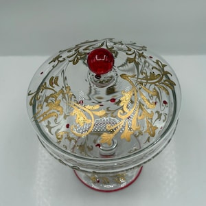 Vintage Glass compote candy dish with gold floral detailing and a red glass finial 9” H