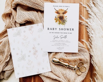 May include: A white baby shower invitation with a watercolor illustration of a Highland cow with flowers. The text reads "Please join us for a baby shower as we honor the mom-to-be Julie Smith. Saturday, October 21, 2023 at three o'clock in the afternoon. 1212 Park Avenue, Jacksonville, Oregon. RSVP to Leanne at 555-111-2123. Registered at Target."