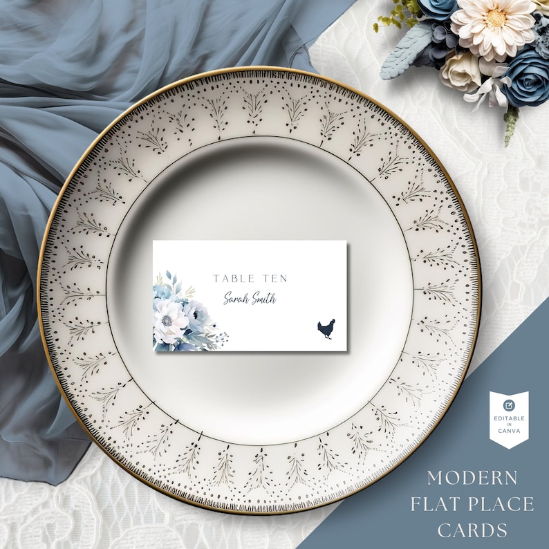 May include: A white place card with a blue floral design and a black silhouette of a chicken. The card reads "Table Ten Sarah Smith".