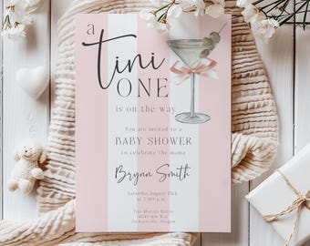 May include: A pink and white striped baby shower invitation with a martini glass illustration and the text "A Tini One is on the way". The invitation includes the details of the event, including the date, time, location, and the name "Brynn Smith".
