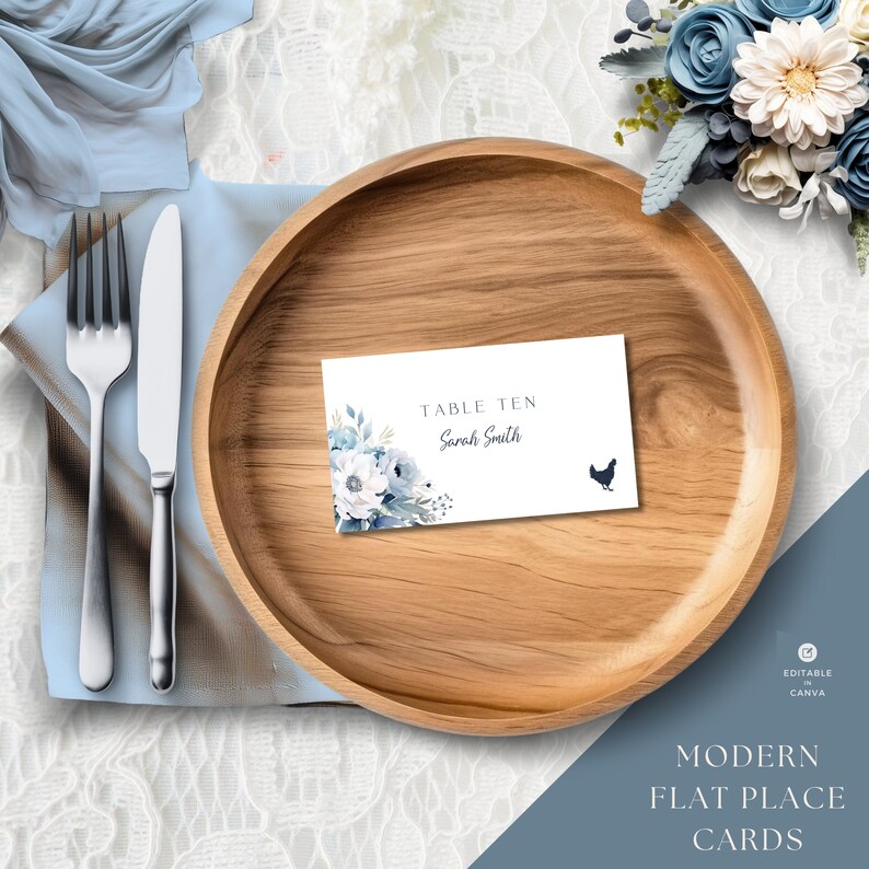 May include: A white place card with blue watercolor flowers and a black silhouette of a chicken. The card reads "Table Ten Sarah Smith". The card is on a wooden plate.