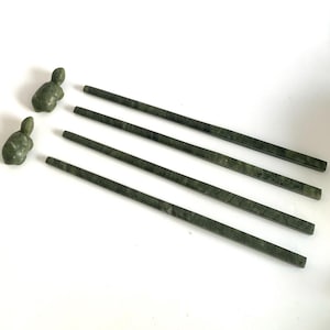 May include: Set of five green marble chopsticks with two green marble turtle figurines.