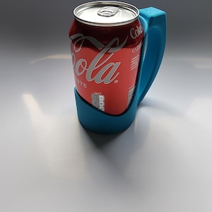 May include: A blue plastic can holder with a Coca-Cola can inside. The can holder has a handle for easy carrying.