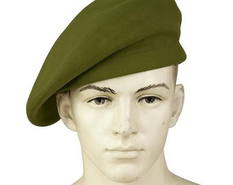 May include: Olive green beret. The beret is made of a soft, felt-like material. The beret is worn at a slight angle. The beret is a classic style, often associated with military and artistic fashion.