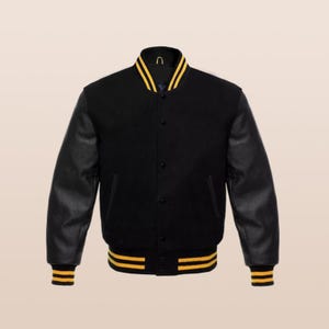 May include: A black varsity jacket with yellow stripes on the collar, cuffs, and waist. The sleeves are black leather, and the jacket has a button-up front. A classic, sporty outerwear garment.