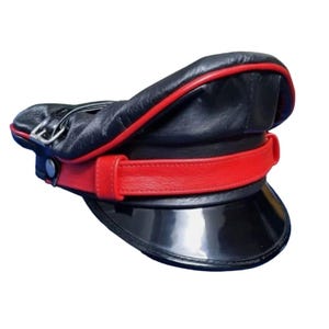 May include: Black leather hat with a red band and trim. The hat features a shiny black brim and a silver buckle detail. The hat is a classic style, with a structured design.